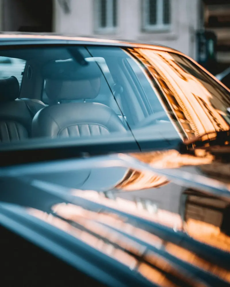 Sunset reflections on a polished roof and windscreen
